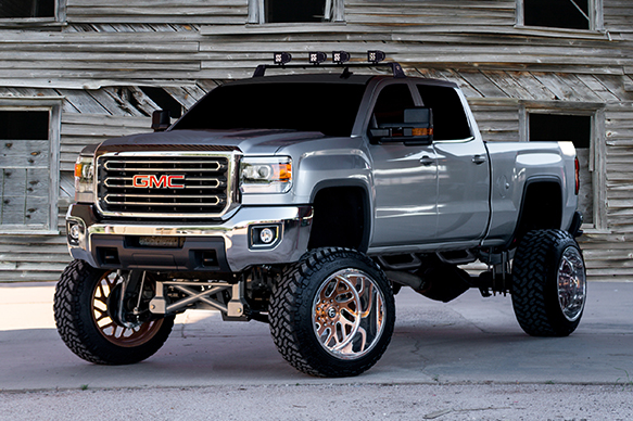 Silver truck with steps and lightbar installed